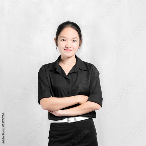 Portrait of a young beautiful asian girl in black uniform. Isola