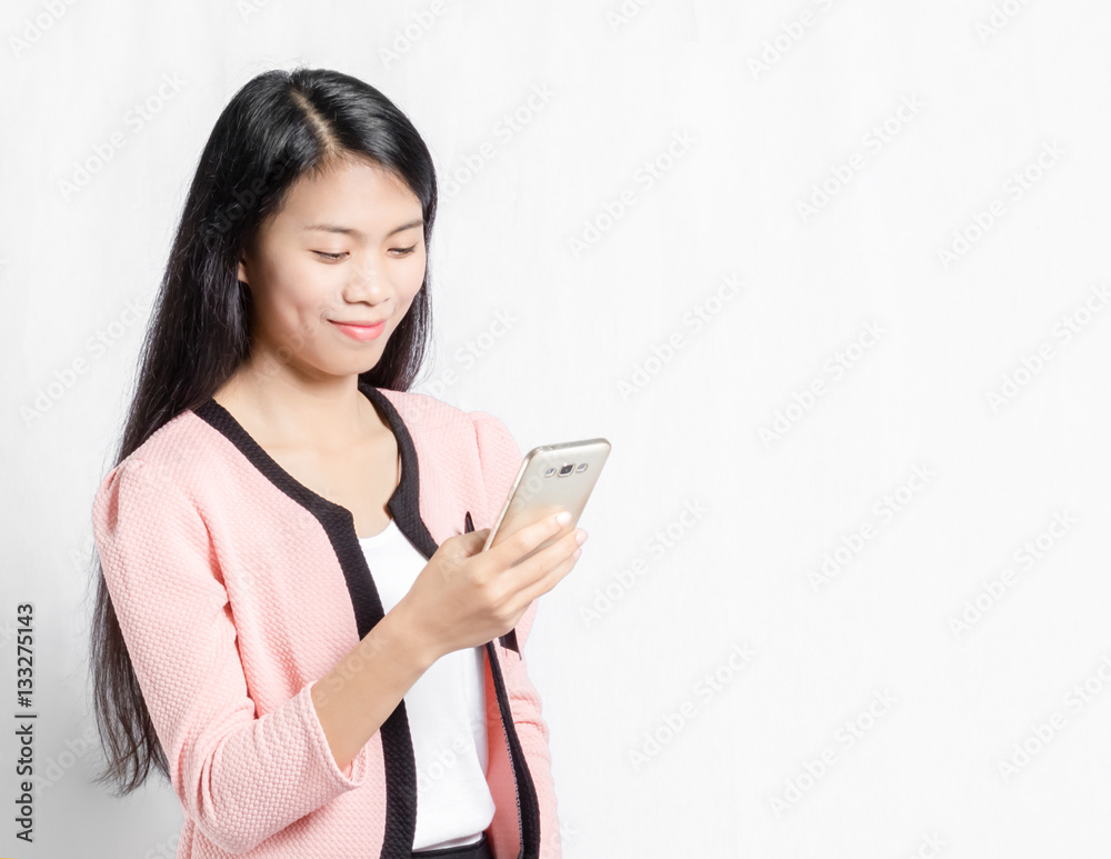 Portrait of a beautiful asian girl looking on smart phone. Isola Portrait of a beautiful asian girl looking on smart phone. Isola