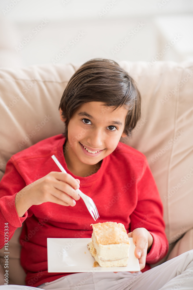 Child inside interior of modern home sitting on sofa Child inside interior of modern home sitting on sofa