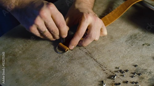 A professional re-enactment craftsman making leather item