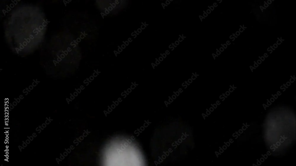 snow at night through the window glass with drops. Flying from left bottom. snow at night through the window glass with drops. Flying from left bottom.