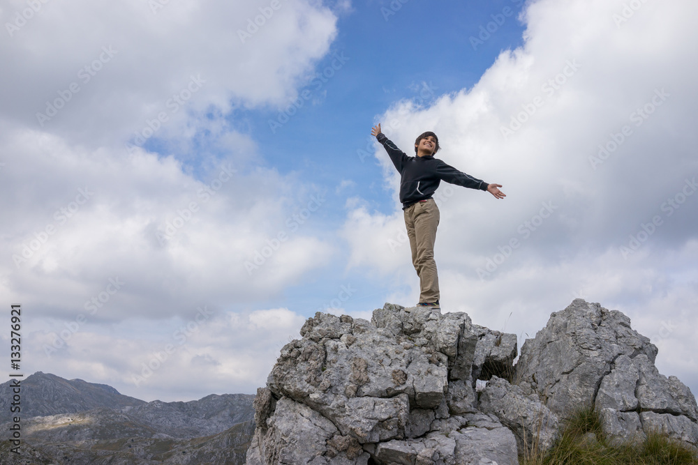 A little boy is climbing on mountain A little boy is climbing on mountain