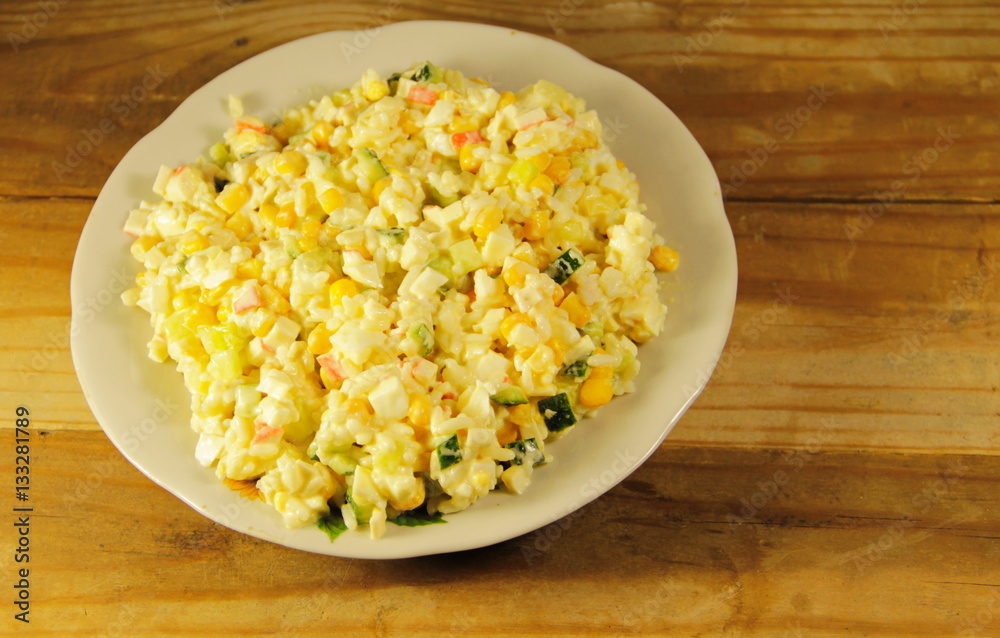 Salad with crab sticks, corn, cucumber, eggs and rice Salad with crab sticks, corn, cucumber, eggs and rice