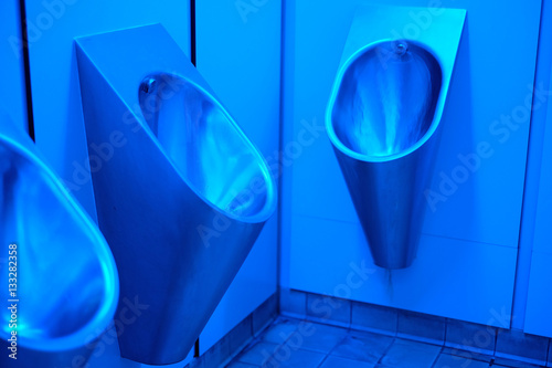 Blue UV lighting in mens urinals to prevent drug use by injection. photo
