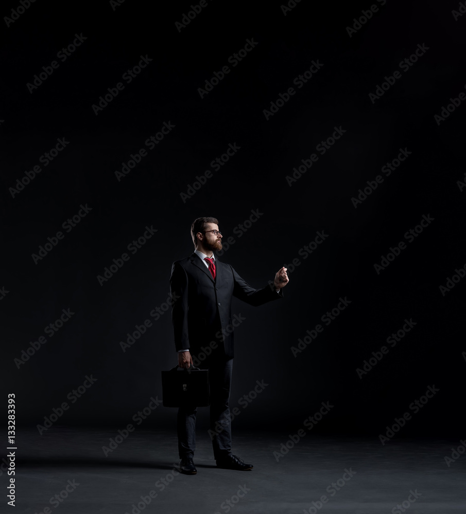 Businessman in a suit and tie writing something Businessman in a suit and tie writing something