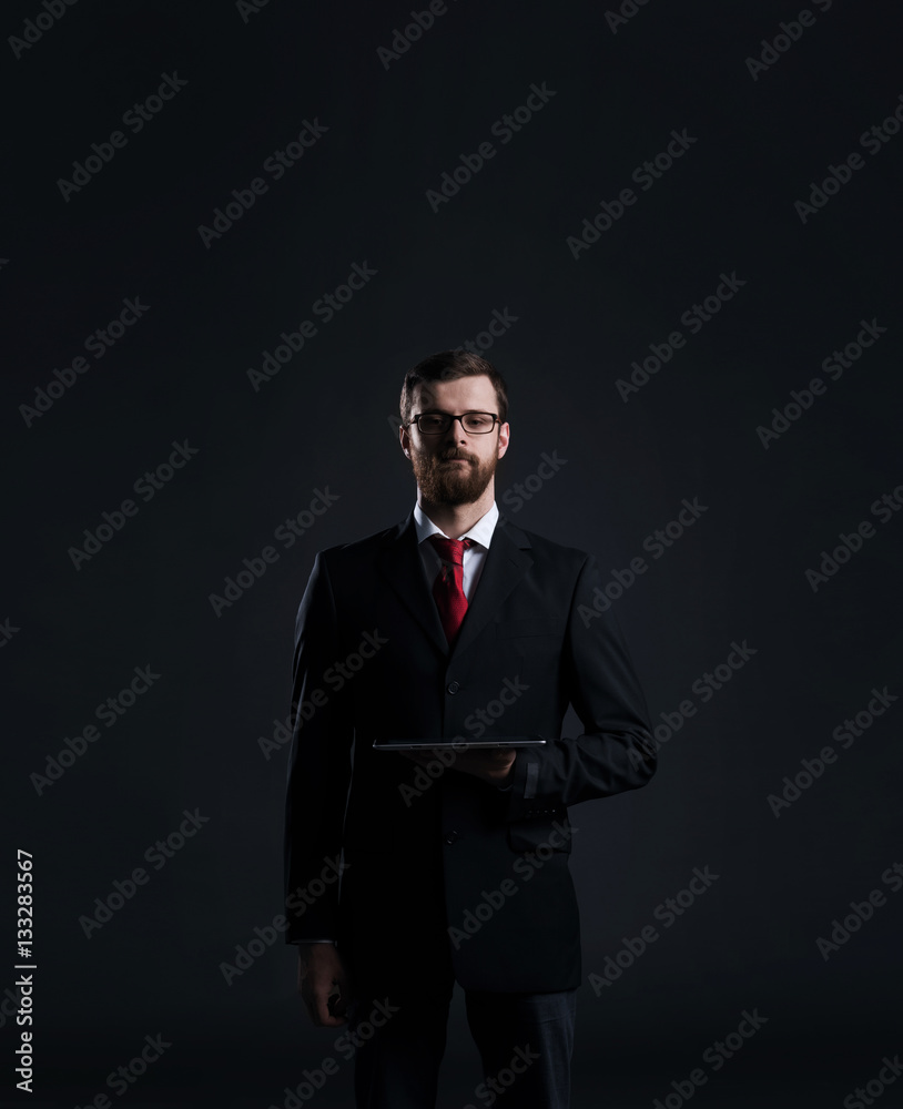 Businessman in a suit and tie holding a tablet Businessman in a suit and tie holding a tablet