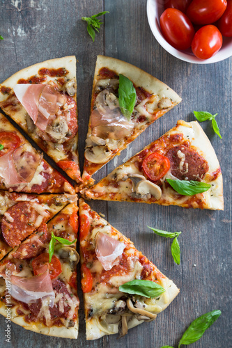 Pizza with salami, mushrooms and herbs