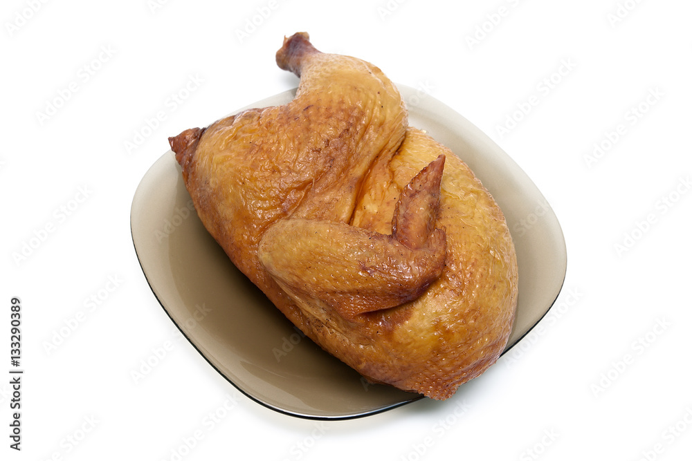 half smoked chicken carcass on a plate on white background