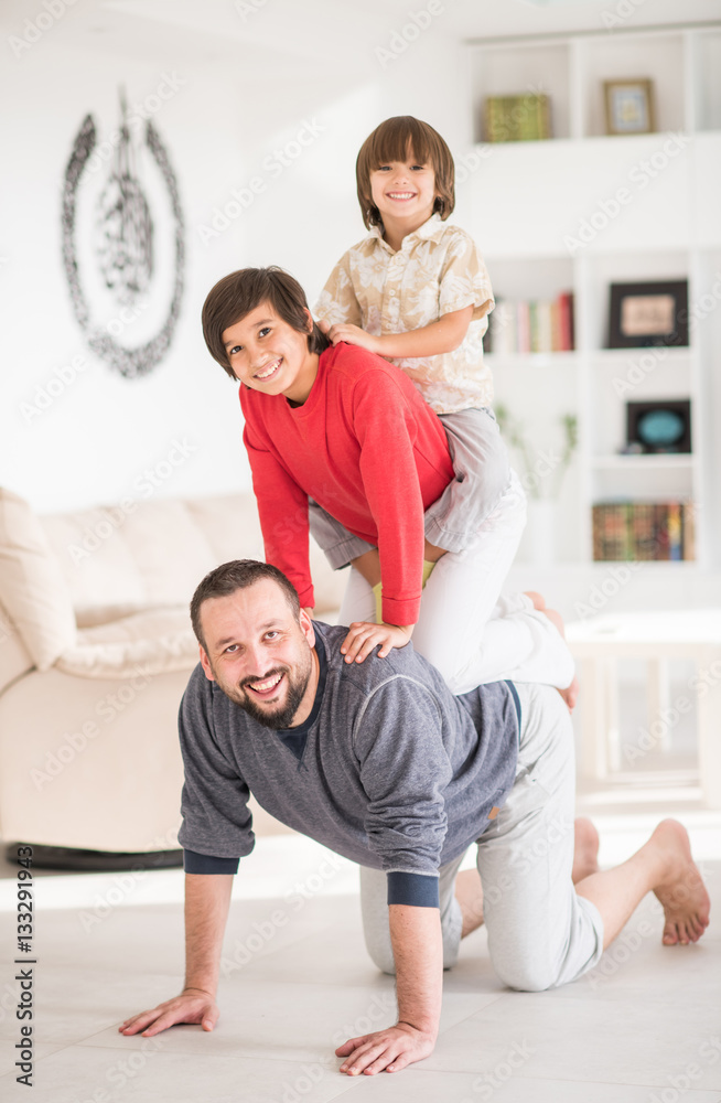 Fototapeta premium Happy father and kids at new modern home