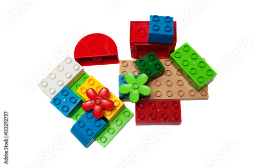 Colorful plastic building bricks on a white background, place fo