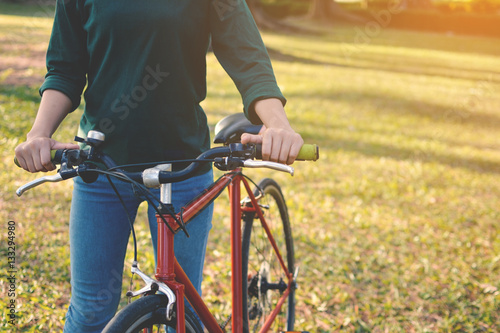 Happy Asian hipster women with bicycle in the park tree background color of vintage tone, Travel on holiday relax time 