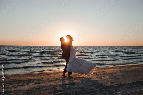 Just Married. Beautiful young couple on the beach at sunset