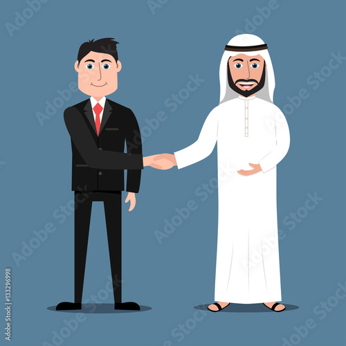 Happy Arab man in traditional dress and a western businessman in suit shaking hands
