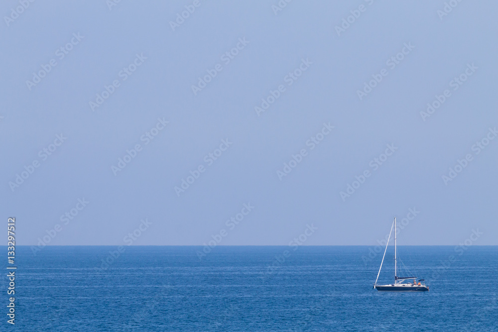 Fototapeta premium Isolated boat on blue sea
