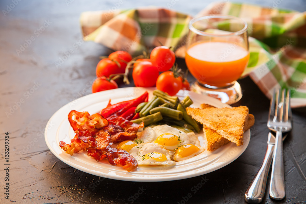 breakfast - fried eggs, haricot, a paprika and bacon in a plate, selective focus breakfast - fried eggs, haricot, a paprika and bacon in a plate, selective focus