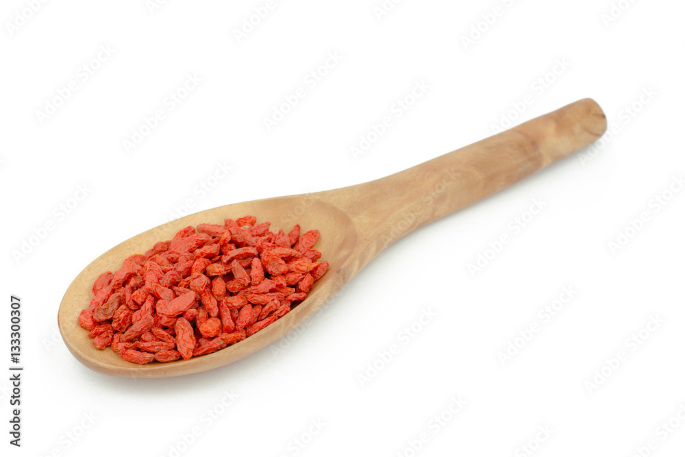 goji berries in wood spoon on white background goji berries in wood spoon on white background