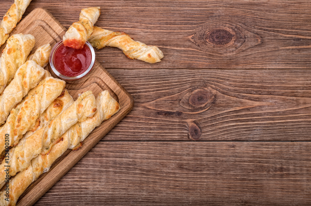 Puff pastry cheese twists. - obrazy, fototapety, plakaty 