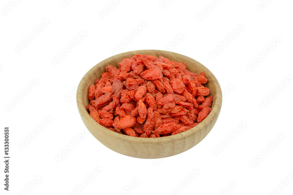 goji berries in wood bowl isolated on white background goji berries in wood bowl isolated on white background