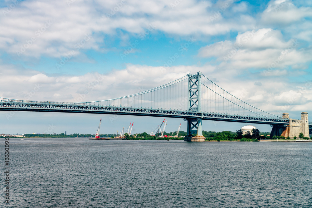 Fototapeta premium View on Delaware river and Benjamin Franklin Bridge. Bridge – is a suspension bridge across the Delaware River connecting Philadelphia, Pennsylvania, and Camden, New Jersey. 