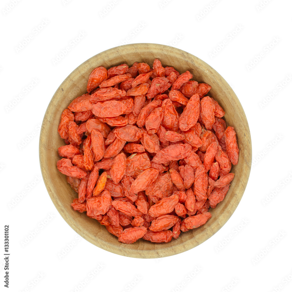goji berries in wood bowl isolated on white background goji berries in wood bowl isolated on white background