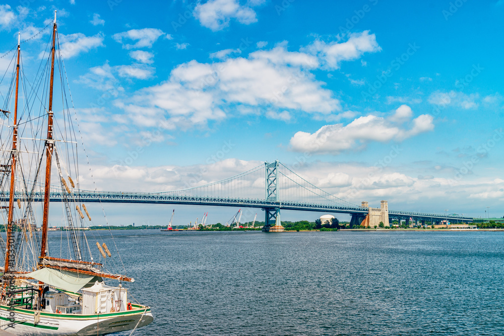 View on Delaware river and Benjamin Franklin Bridge. Bridge – is a suspension bridge across the Delaware River connecting Philadelphia, Pennsylvania, and Camden, New Jersey. 