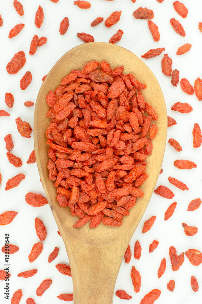 goji berries in wood spoon on white background
