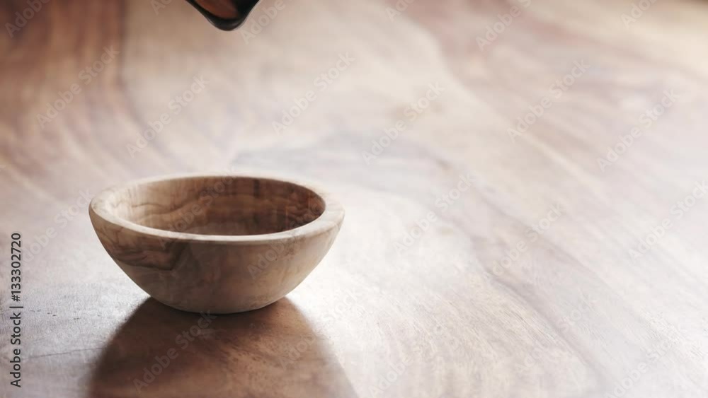 almonds falling in wood bowl on wooden table in slow motion, 180fps prores footage almonds falling in wood bowl on wooden table in slow motion, 180fps prores footage