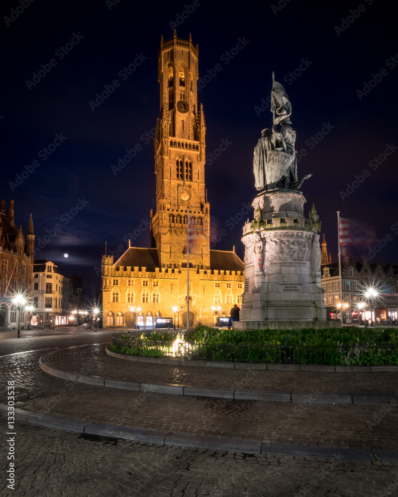 Bruges Market Place and Belfort at night. Wide angle, night view of the central market square in the Belgian town of Bruges, Belgium.
