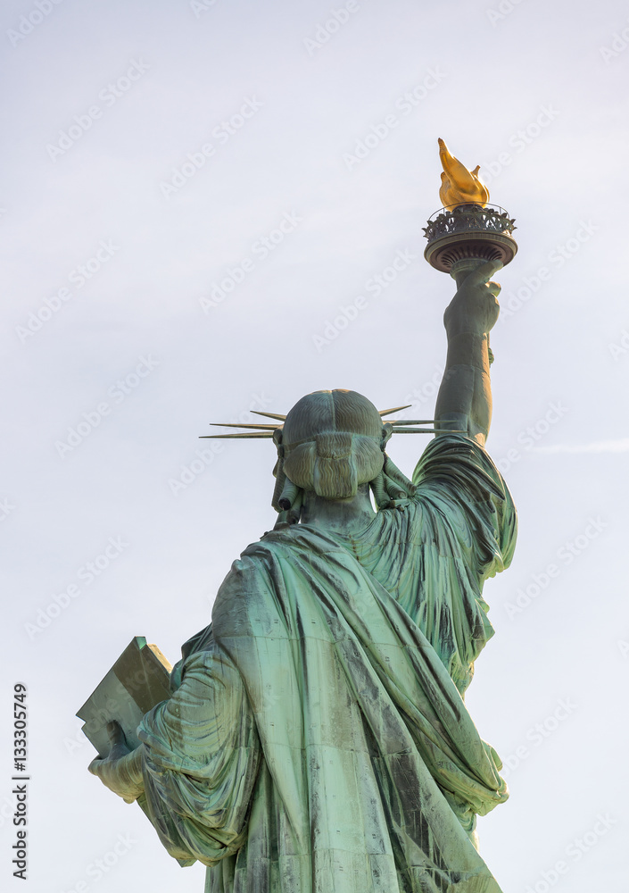 Fototapeta premium Back view of Statue of Liberty from street level, New York