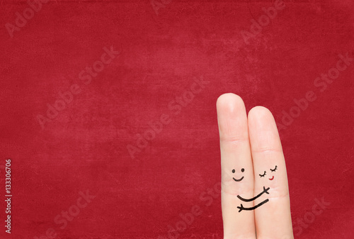 couple in love with painted smiley. Painted smiley and hugging