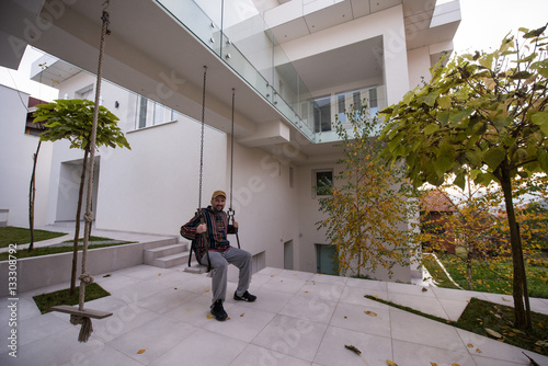 Man living his dream in front of his new modern house © Jasmin Merdan
