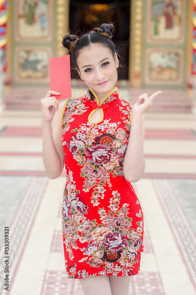 happy Chinese new year. Asian girl with gesture of congratulation and holding red envelope on White background happy Chinese new year. Asian girl with gesture of congratulation and holding red envelope on White background