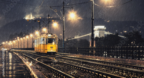 Yellow tram in the rainy night