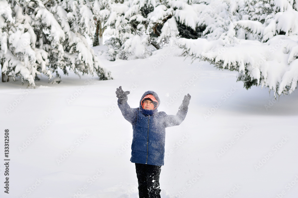 The magic of winter . Child having fun, playing with snow. The magic of winter . Child having fun, playing with snow.