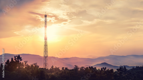 Beautiful sunset over the hills with a cell tower