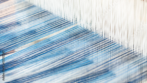 Closeup, abstract motion blur of silk fabric weaving photo