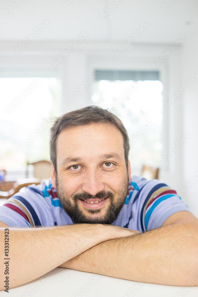 Attractive smiling man relaxing at home Attractive smiling man relaxing at home