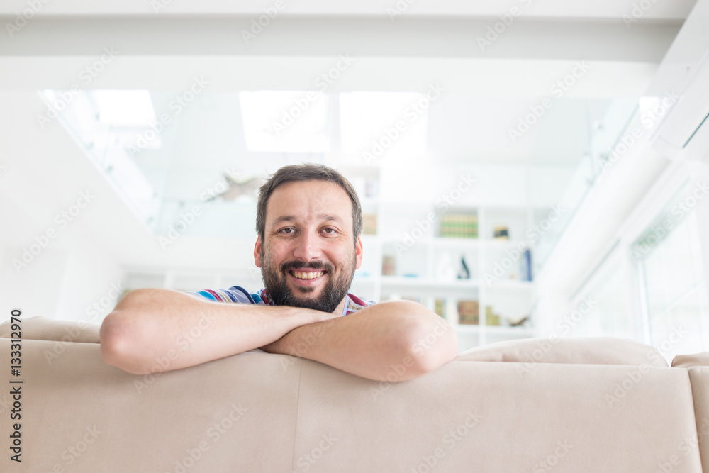 Attractive smiling man relaxing at home