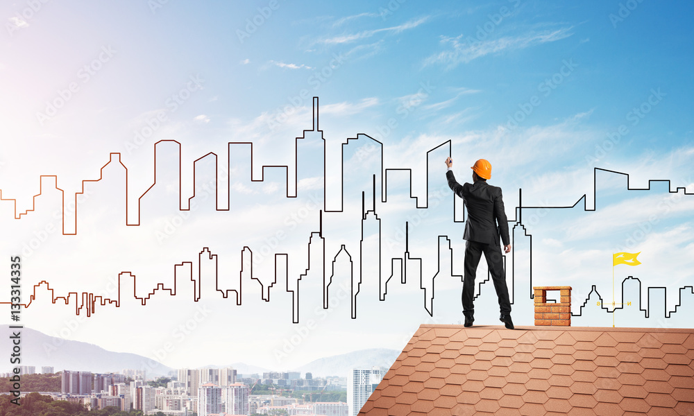 Man architect draw silhouette of modern city on blue sky. Mixed media Man architect draw silhouette of modern city on blue sky. Mixed media