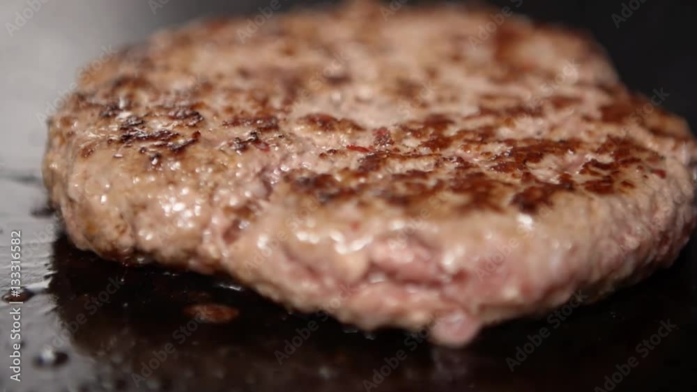 Burger on a grill. A barbecue scene with burger. Shallow depth of field. Burger on a grill. A barbecue scene with burger. Shallow depth of field.