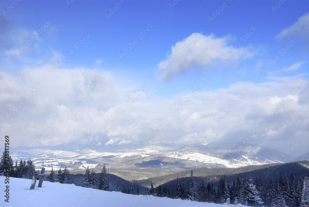 Fototapeta premium Contrast transition between ground end sky. Dramatic clouds under snowed mountains 