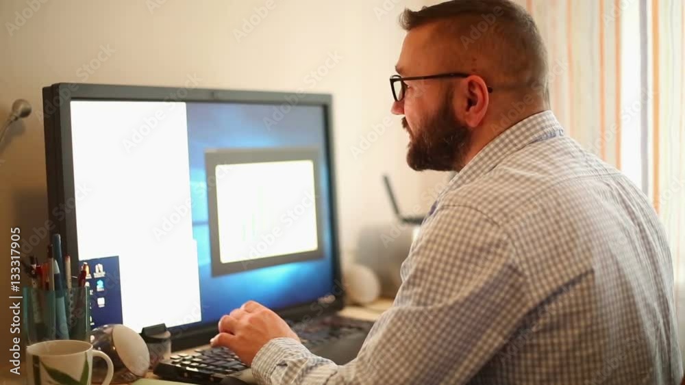 Young businessman in home office working on computer chief executive typing email
Young businessman in home office working on computer chief executive typing email