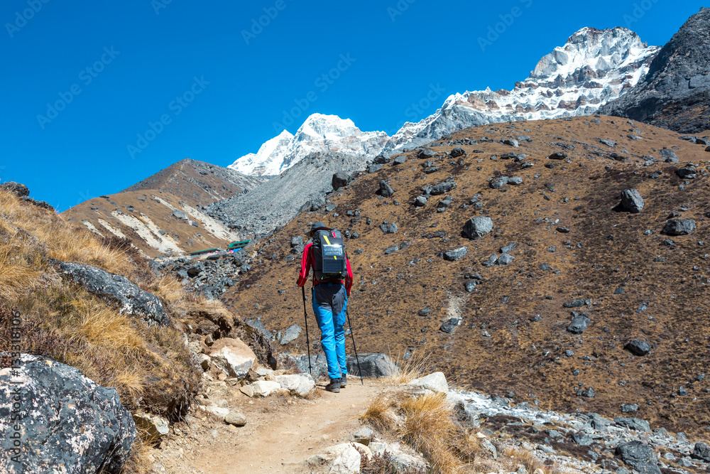 Mountain Hiker walking with Backpack and Solar Battery
