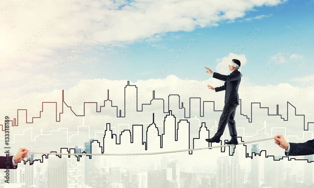 Business concept of risk support and assistance with man balancing on rope