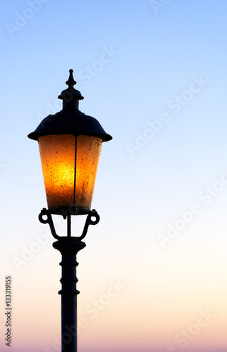 Old lamp in sunset