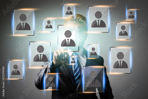 Young businessman pointing  digital people icon network applicat photo