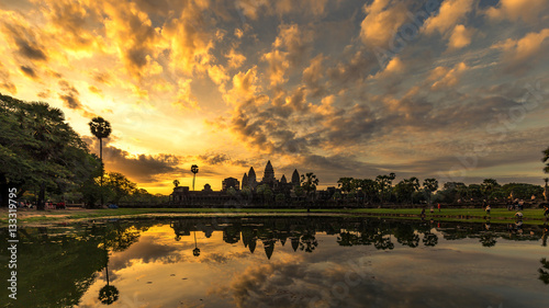Angkor Wat in Siem Reap, Cambodia during sunrise with reflection in water.