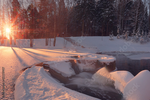 Winter sun illuninate small waterfall photo