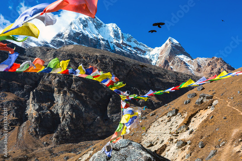 View of high Mountains and Nepalese buddhist prayer Flags photo