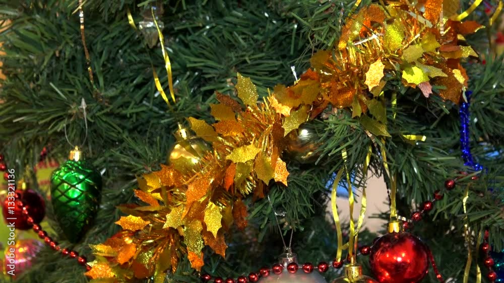 Festive Christmas tree with balls and toys close. New Year accessory for the home. Festive Christmas tree with balls and toys close. New Year accessory for the home.